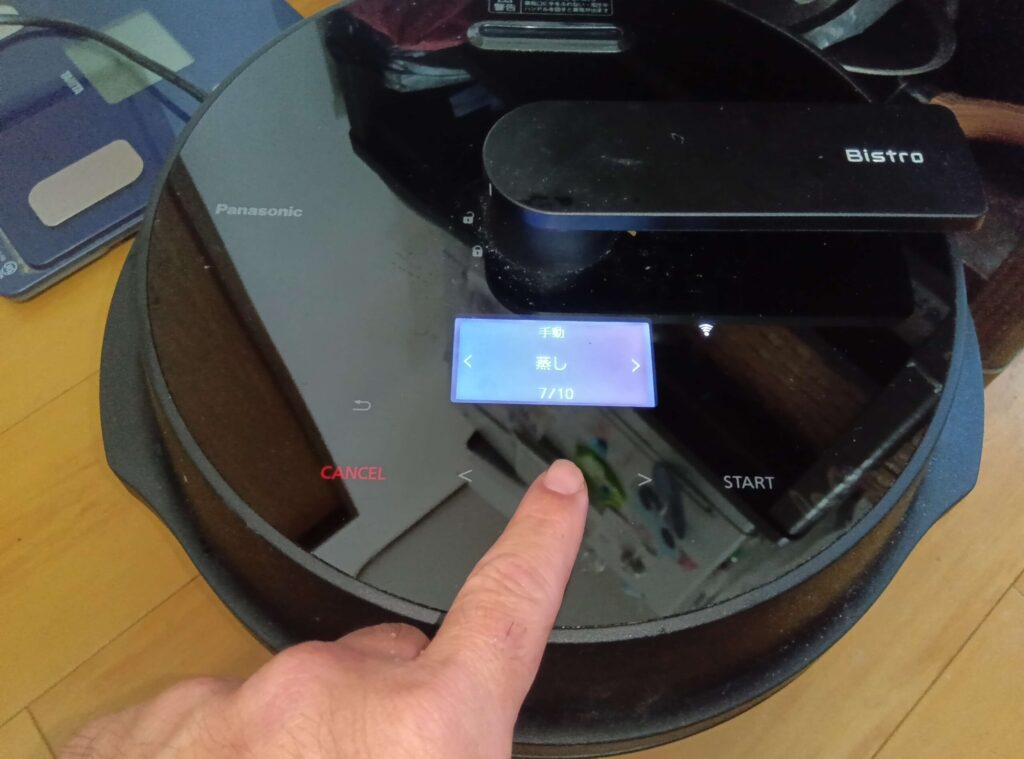 オートクッカービストロNF-AC1000のタッチパネルで蒸しメニューを選択する様子